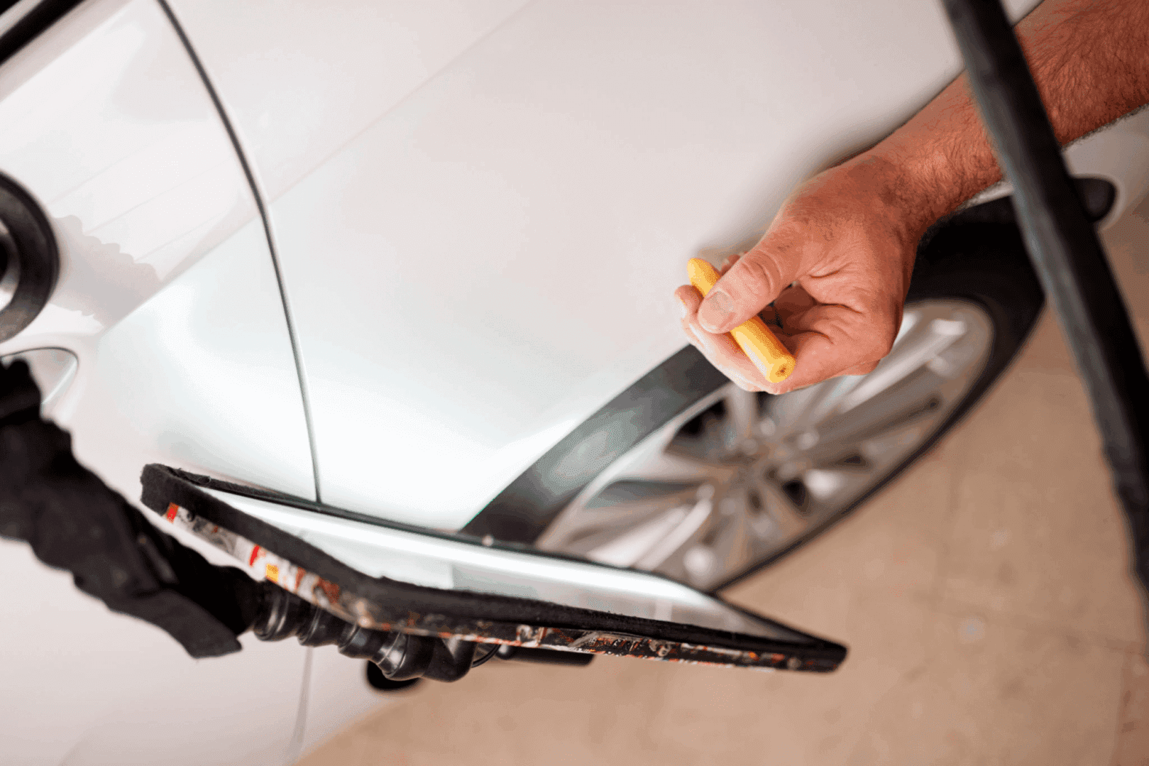 Car dent repair with inspection light.